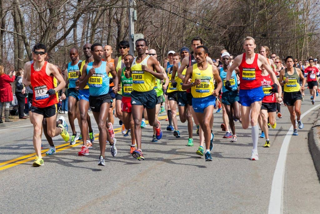 Men running on the road, Boston Marathon