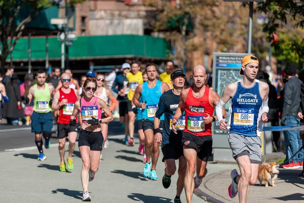 Runners pass through Harlem in New York near the 22 mile mark near Mount Morris Park
