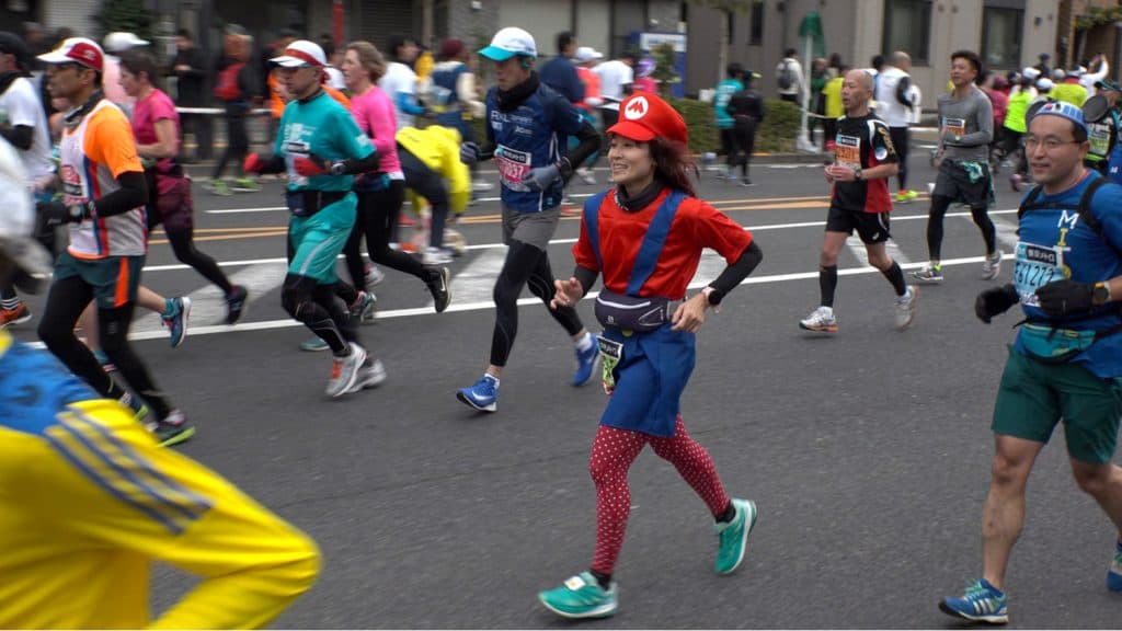 Tokyo Marathon, girl runs in Mario cosplay outfit