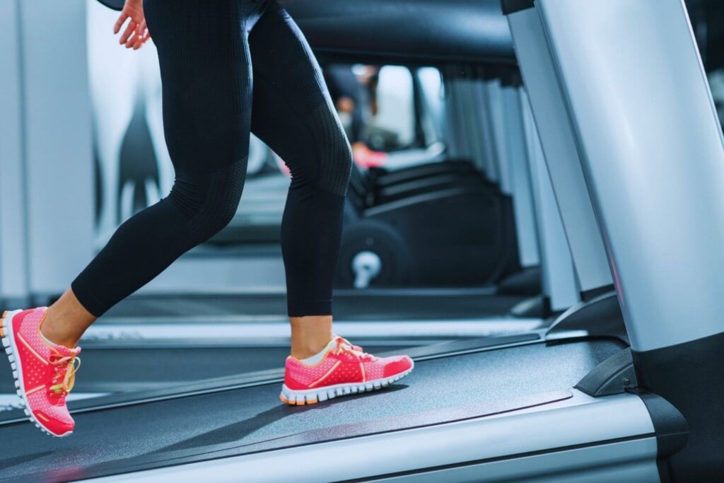 woman using a treadmill as a great training tool to target muscle groups