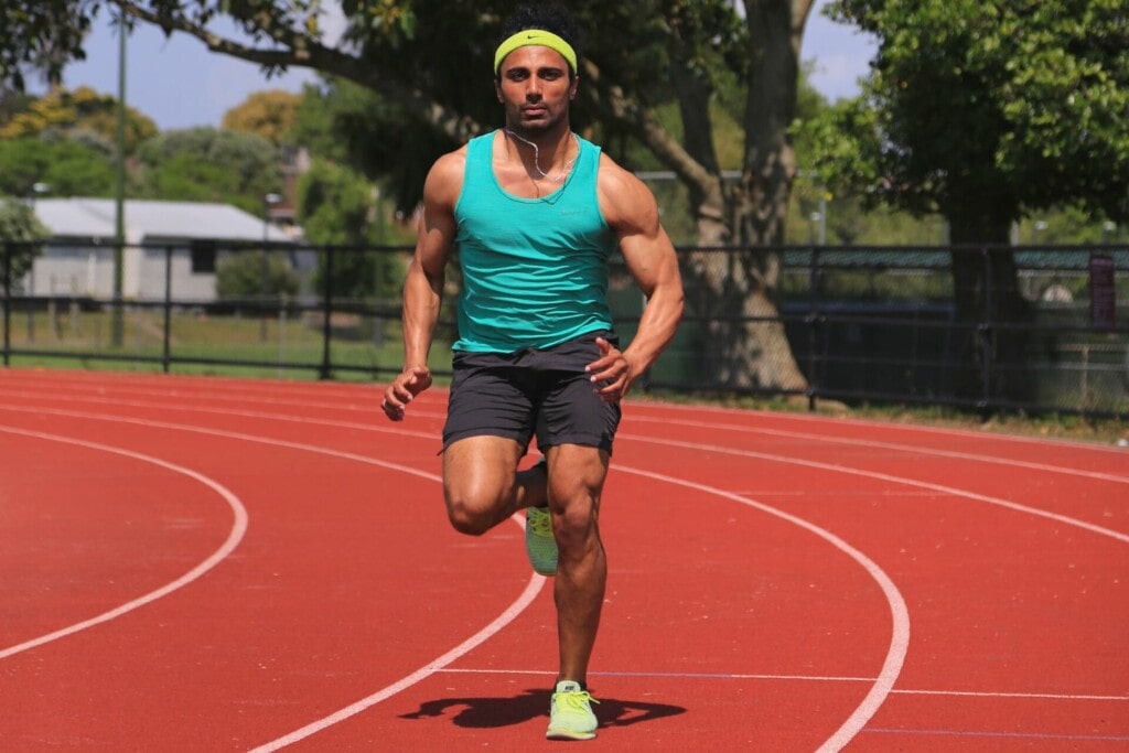a male runner doing interval training on the track