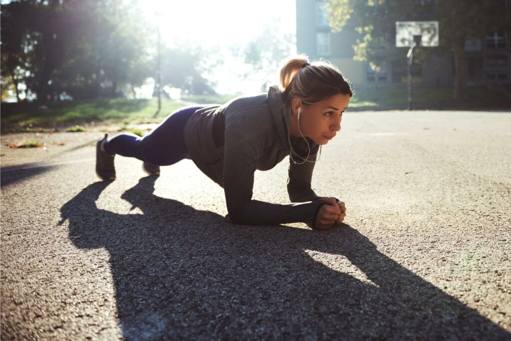 female runner doing a plank