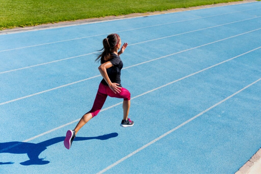woman running at full speed on the track