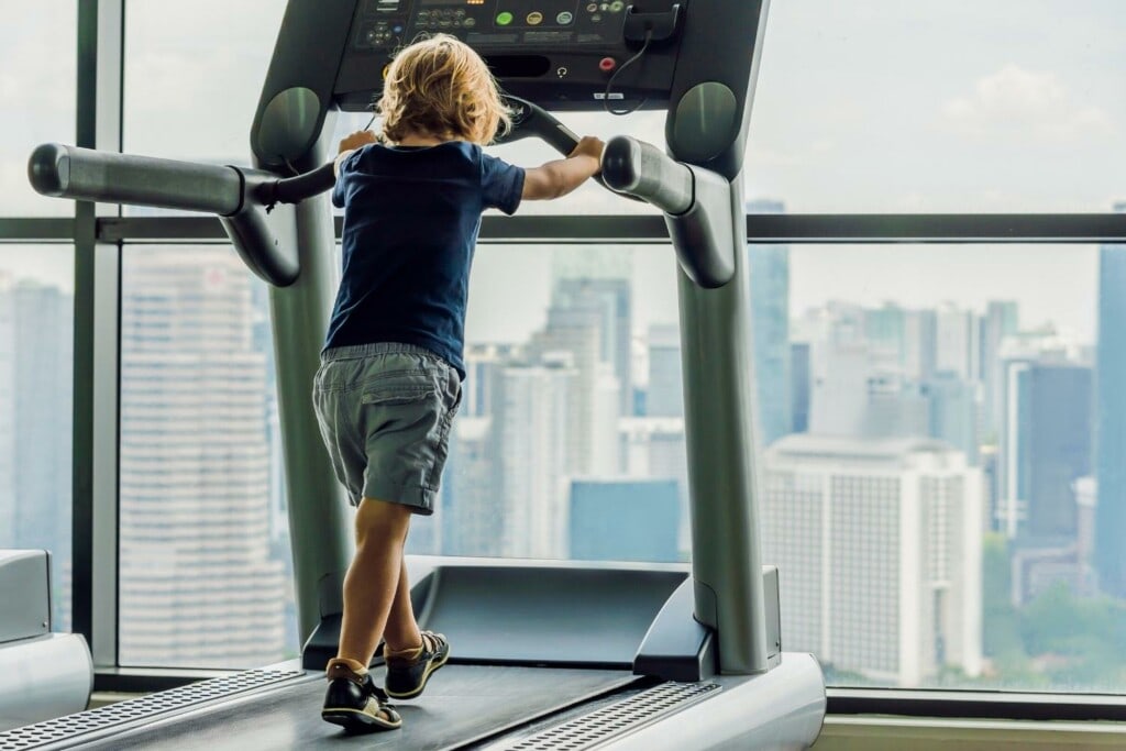 a child boy walking on a treadmill