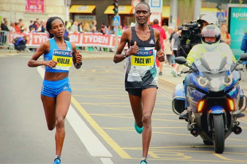 woman runner next to an official pacer