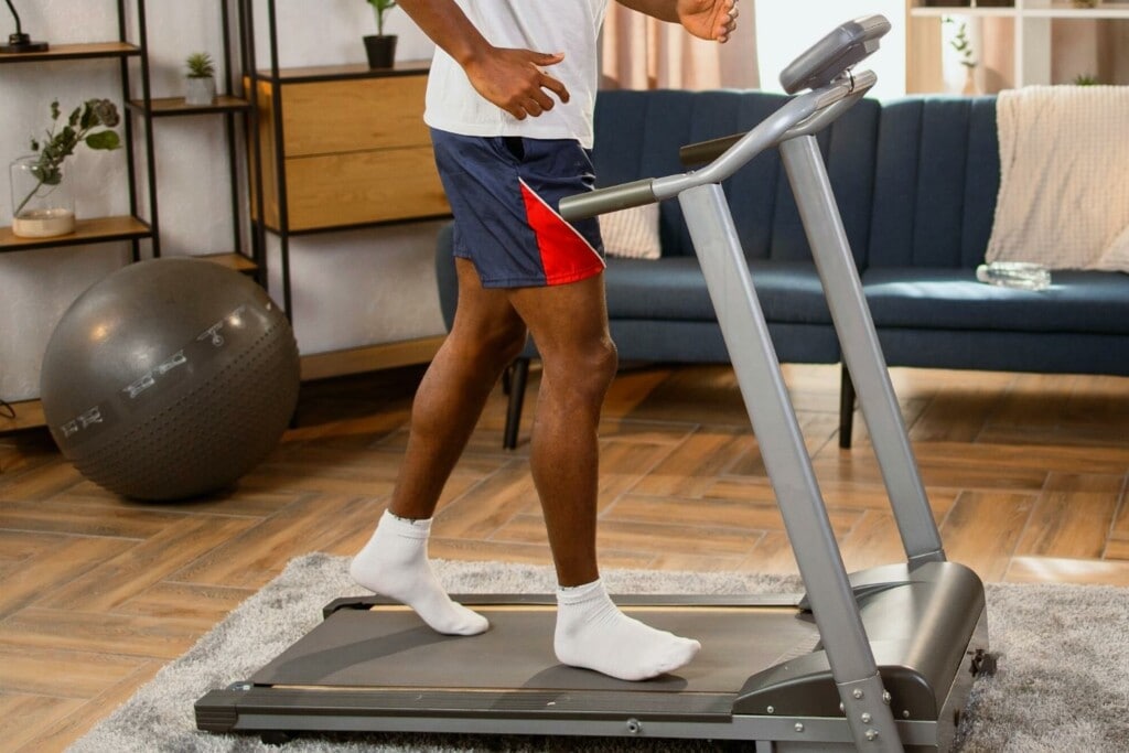 man running on a treadmill without shoes