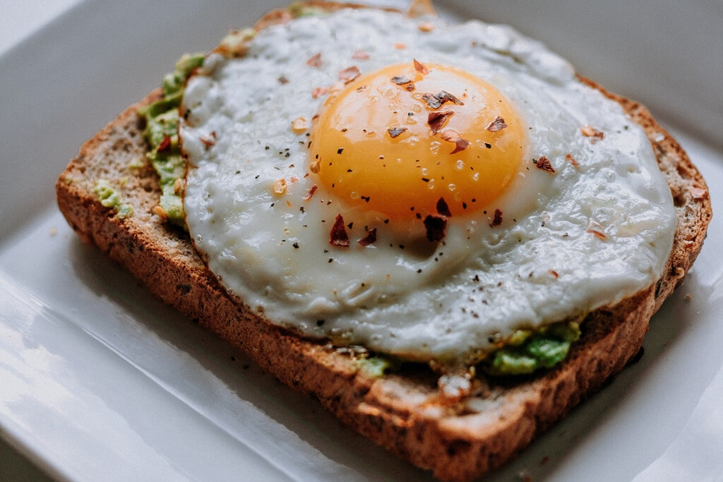 fried egg with avocado on a toasted bread