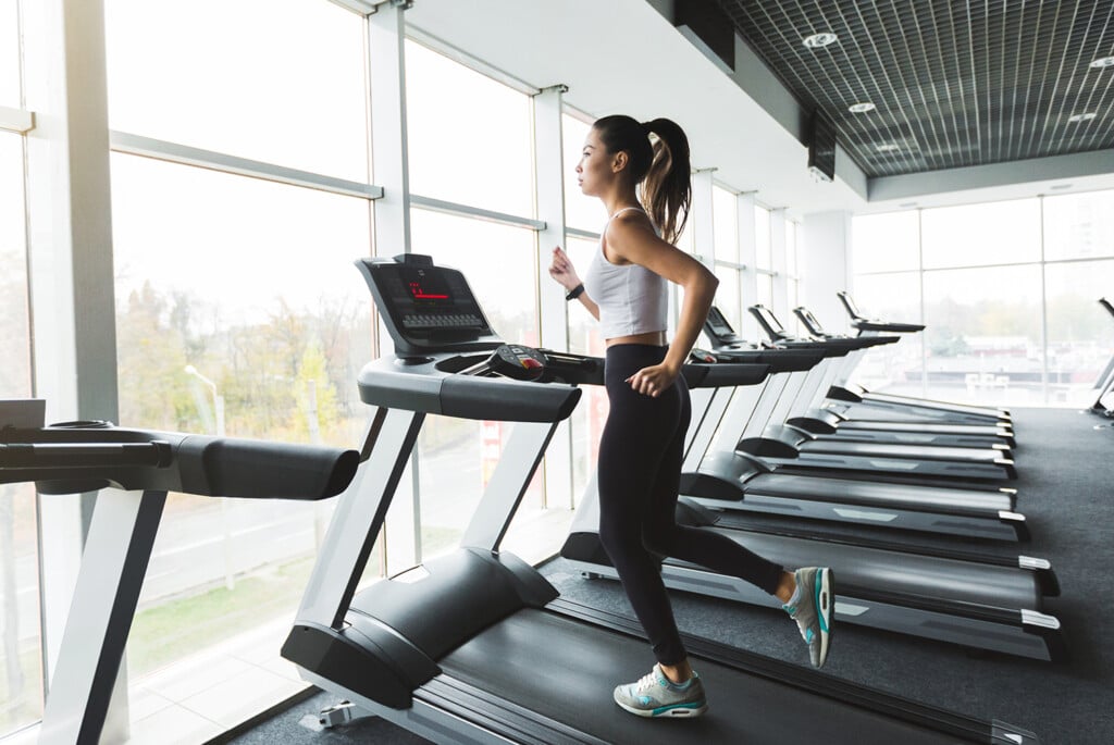 fit woman incline training on treadmill