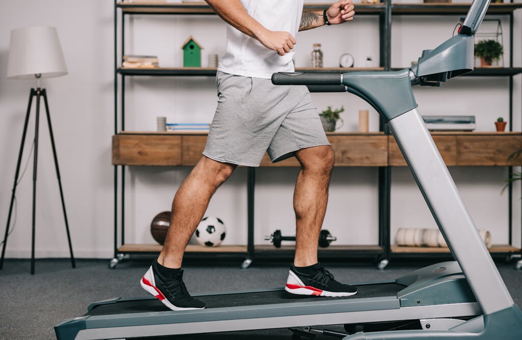 man exercising at home on treadmill