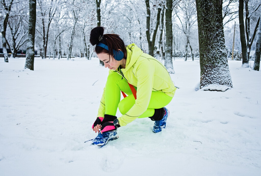 Fitness woman running during winter workout