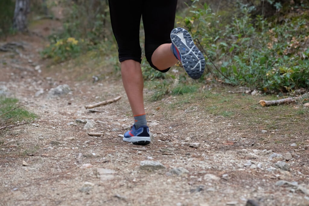 runner wearing Brooks Divide 4 on a trail