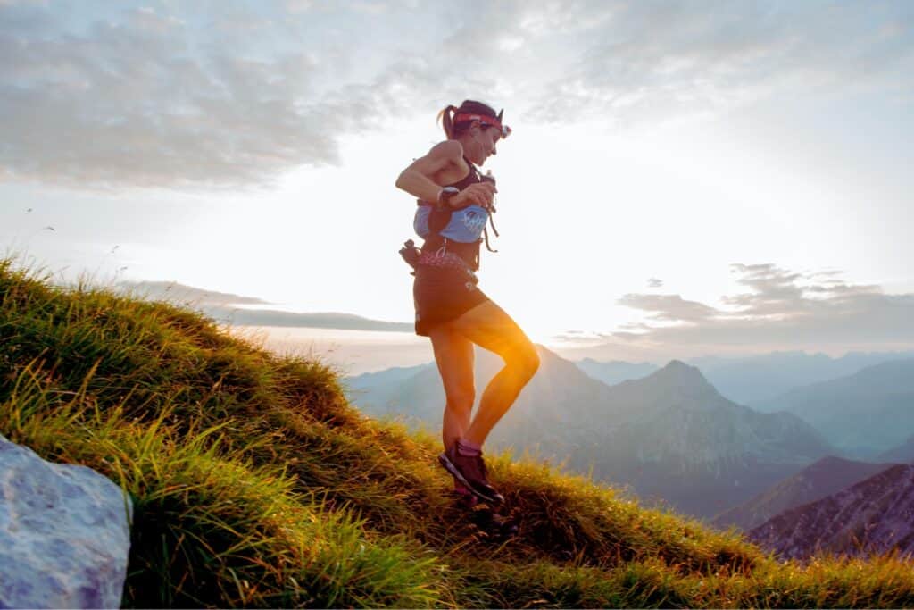 Woman trail running down a trail