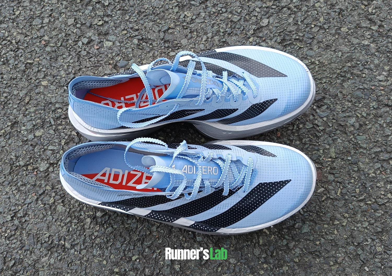 Pair of Adidas Adios Pro 5 seen from above on the asphalt